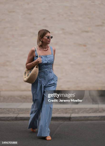 Aline Kaplan wearing Veronica Beard striped blue, green, white cropped top and Veronica Beard matching wide leg pants, Sezane raffia round bag, &...