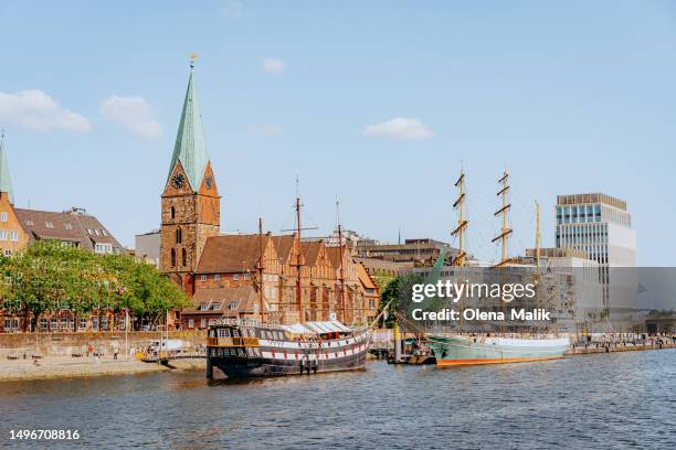 view to boardwalk schlachte, saint martin's church and martini landing pier in bremen, germany - bremen stock pictures, royalty-free photos & images