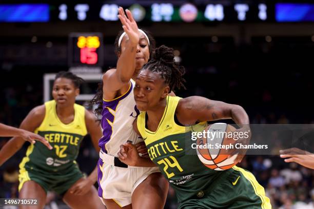 Jewell Loyd of the Seattle Storm dribbles against Lexie Brown of the Los Angeles Sparks during the third quarter at Climate Pledge Arena on June 06,...