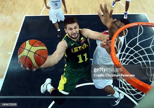 Linas Kleiza of Lithuania shoots against Kevin Seraphin of France during the Men's Basketball Preliminary Round match on Day 6 of the London 2012...