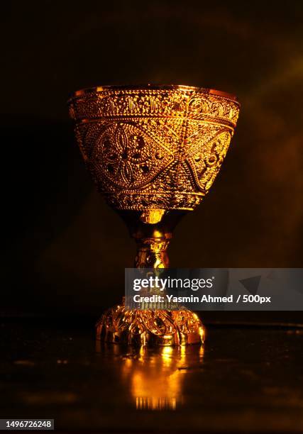 close-up of illuminated lamp on table against black background,bab sharqi,alexandria governorate,egypt - cáliz fotografías e imágenes de stock