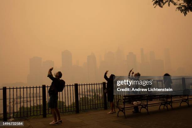 In the middle of the afternoon, smoke from Canadian forest fires blankets the skyline of New York City, June 7 as seen from Brooklyn, New York. The...