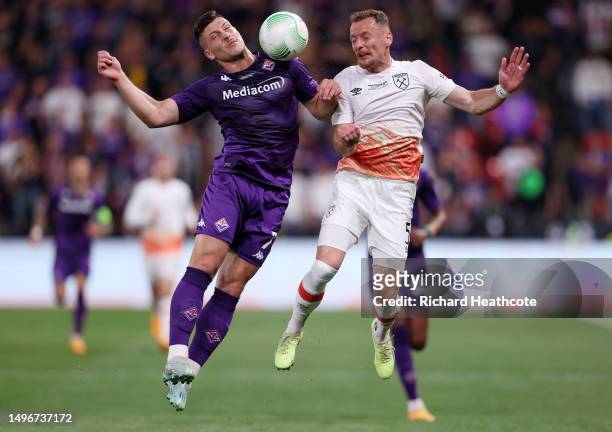 Luka Jovic of ACF Fiorentina jumps for the ball with Vladimir Coufal of West Ham United during the UEFA Europa Conference League 2022/23 final match...