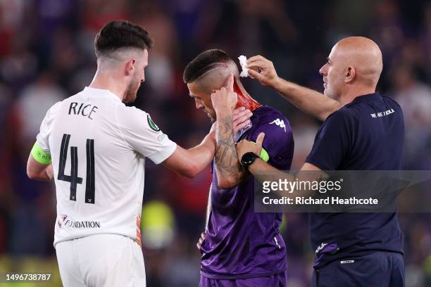 Cristiano Biraghi of ACF Fiorentina receives medical treatment as Declan Rice of West Ham United interacts with him during the UEFA Europa Conference...