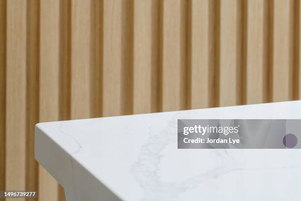 table with wooden wall - marmor stock-fotos und bilder
