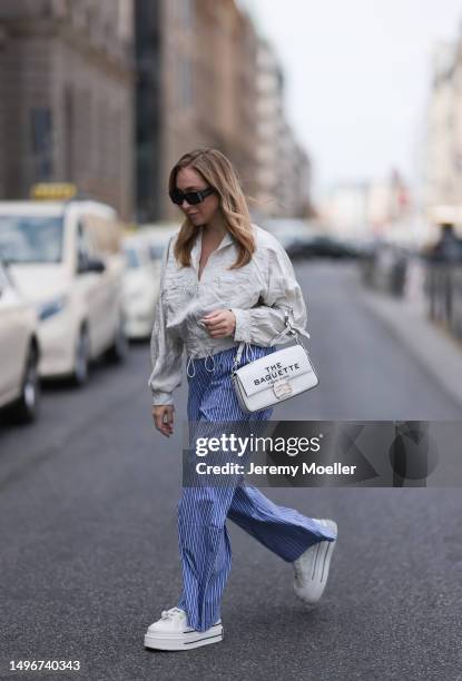 Sonia Lyson wearing Fendi x Marc Jacobs Baguette white leather logo bag, platform white sneaker and cropped beige puffer jacket, The Frankie Shop...