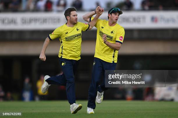 Liam Dawson of Hampshire celebrates with team mate John Turner after dismissing Tom Banton of Somerset during the Vitality Blast T20 match between...