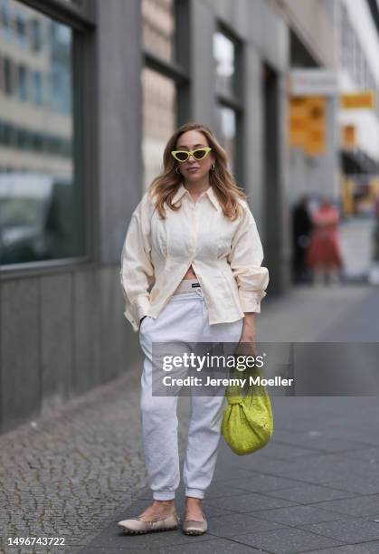 Sonia Lyson wearing Bottega Veneta lime yellow Jodie leather bag, Tods beige ballerinas, H&M grey joggingpants, Miu Miu beige logo underwear, & other...