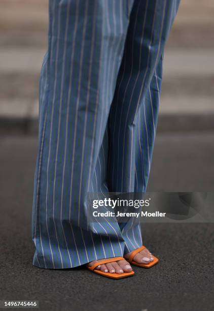 Aline Kaplan wearing Veronica Beard striped blue, green, white cropped top and Veronica Beard matching wide leg pants, Sezane raffia round bag, &...