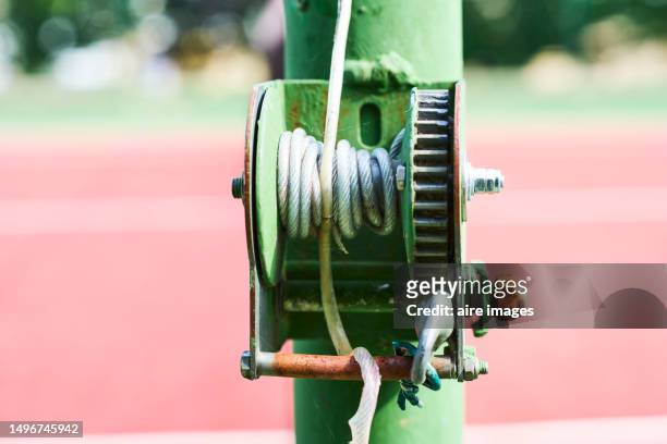close-up of a metal poplar with a white door on a pole on the back of a tennis court, front view - water whorl grass stock pictures, royalty-free photos & images
