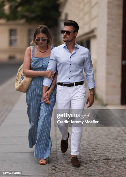 Aline Kaplan wearing Veronica Beard striped blue, green, white cropped top and Veronica Beard matching wide leg pants, Sezane raffia round bag, &...