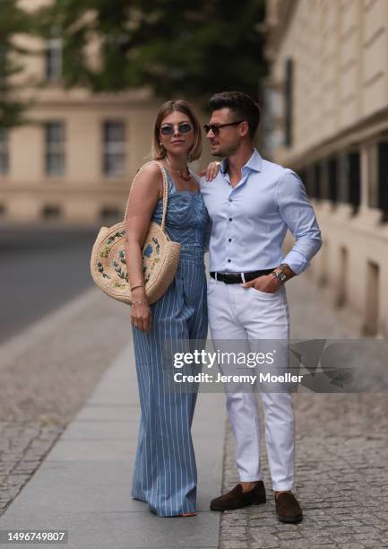 Aline Kaplan wearing Veronica Beard striped blue, green, white cropped top and Veronica Beard matching wide leg pants, Sezane raffia round bag, &...