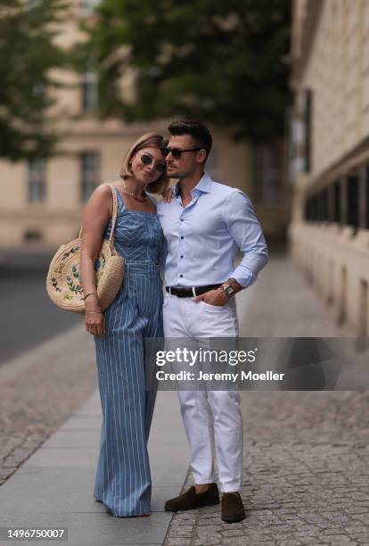 Aline Kaplan wearing Veronica Beard striped blue, green, white cropped top and Veronica Beard matching wide leg pants, Sezane raffia round bag, &...