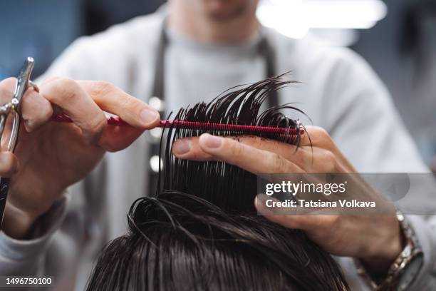 young male hairdresser creating contemporary hairstyle for teenage boy - hair cut for teen boys stock pictures, royalty-free photos & images