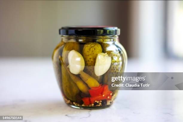 jar of pickles on kitchen table - pickle jar imagens e fotografias de stock