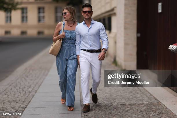 Aline Kaplan wearing Veronica Beard striped blue, green, white cropped top and Veronica Beard matching wide leg pants, Sezane raffia round bag, &...