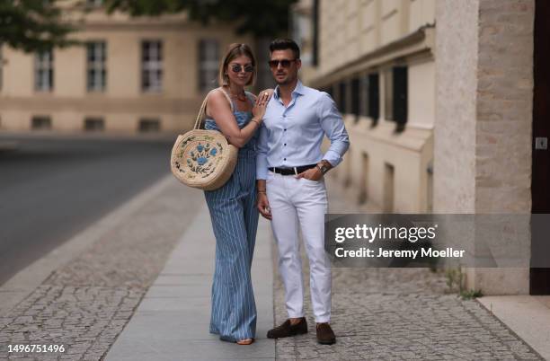 Aline Kaplan wearing Veronica Beard striped blue, green, white cropped top and Veronica Beard matching wide leg pants, Sezane raffia round bag, &...