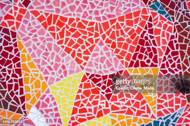 colorful broken pieces of ceramic tiles creating geometric shapes on exterior wall - the mosaica stock pictures, royalty-free photos & images