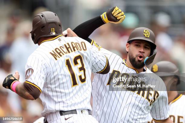 Manny Machado congratulates Gary Sanchez of the San Diego Padres after his three run homerun during the third inning of a game at PETCO Park on June...