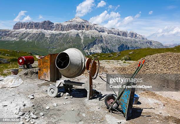 Construction work on the rki run with a cement mixer and a wheelbarrow along the mountain trails to the mountain station of the skiing area Porta...