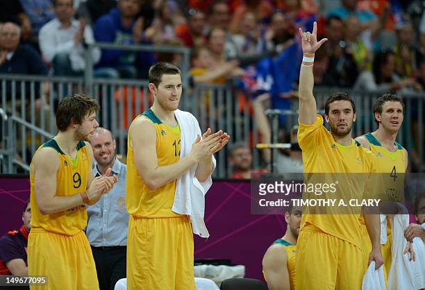 Australian guard Matt Dellavedova , Australian centre Aron Baynes and Australian guard Adam Gibson celebrate at the end of the men's preliminary...