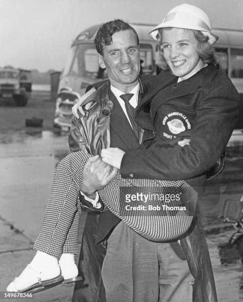 Marion Edwards, a British contestant in the table tennis event, being carried to her aircraft at London Airport, 16th September 1960. She is en route...
