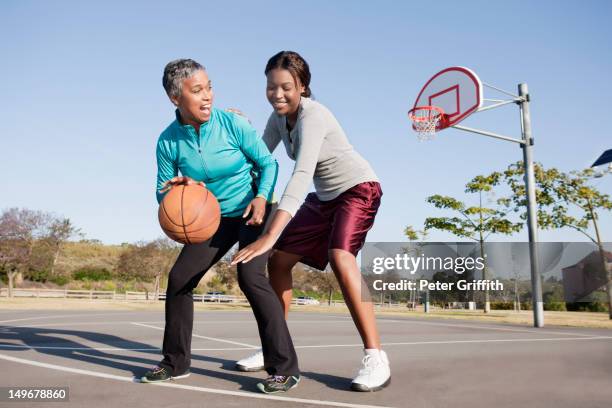 mother and daughter playing basketball - basketball action stock pictures, royalty-free photos & images