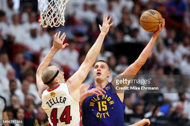 Nikola Jokic of the Denver Nuggets drives to the basket against Cody Zeller of the Miami Heat during the second quarter in Game Three of the 2023 NBA...