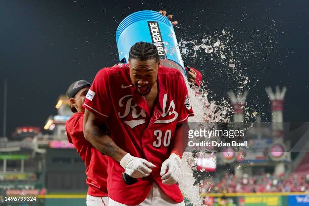 Will Benson of the Cincinnati Reds is doused with water after hitting a walk-off home run in the ninth inning to beat the Los Angeles Dodgers 8-6 at...
