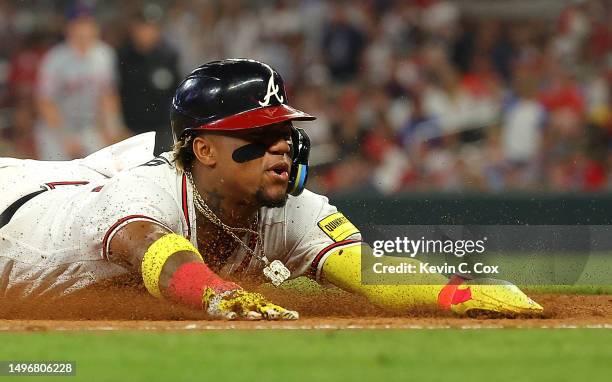 Ronald Acuna Jr. #13 of the Atlanta Braves steals third base in the eighth inning against the New York Mets at Truist Park on June 07, 2023 in...