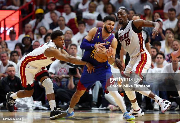 Jamal Murray of the Denver Nuggets dribbles against the double team of Bam Adebayo and Kyle Lowry of the Miami Heat during the fourth quarter in Game...