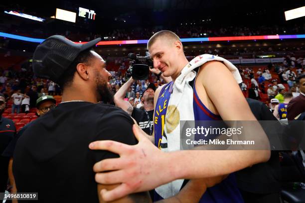 Nikola Jokic of the Denver Nuggets reacts with Monte Morris of the Washington Wizards after a 109-94 victory against the Miami Heat in Game Three of...