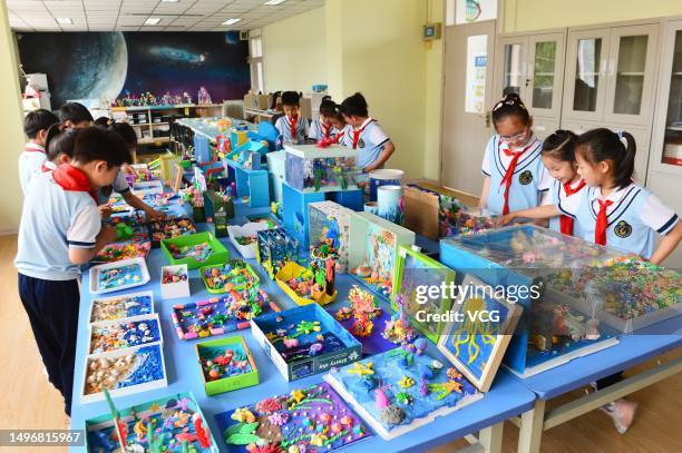 Primary school students make clay figurines to mark World Oceans Day on June 7, 2023 in Qingdao, Shandong Province of China. World Oceans Day is...