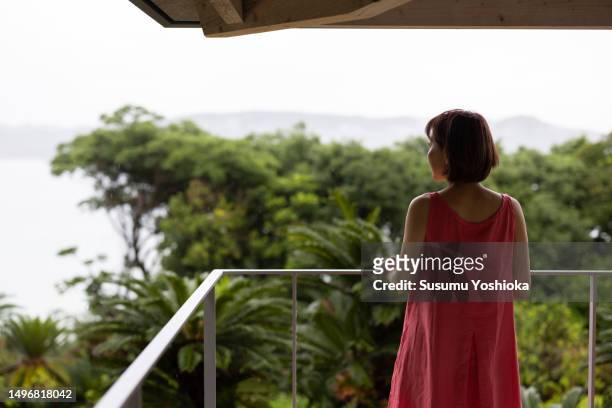 a couple enjoys staying in a villa on vacation. - content japanese ethnicity stock pictures, royalty-free photos & images