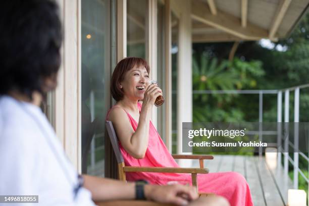 a couple enjoys staying in a villa on vacation. - 鹿児島県 stock pictures, royalty-free photos & images