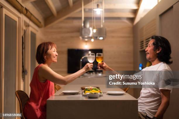 a couple enjoys staying in a villa on vacation. - evening meal - fotografias e filmes do acervo