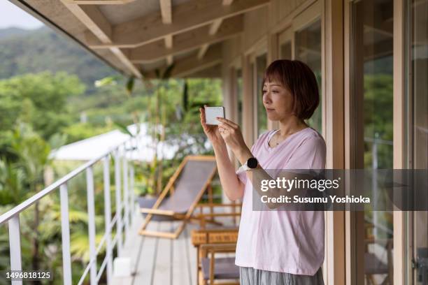 a couple enjoys staying in a villa on vacation. - 鹿児島県 stock pictures, royalty-free photos & images