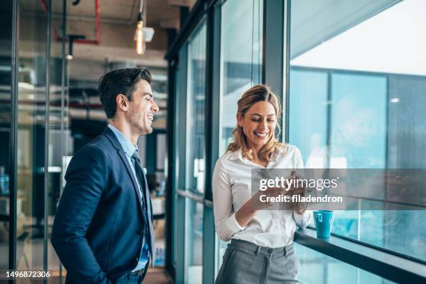 business colleagues talking - businesswoman talking smartphone stock pictures, royalty-free photos & images