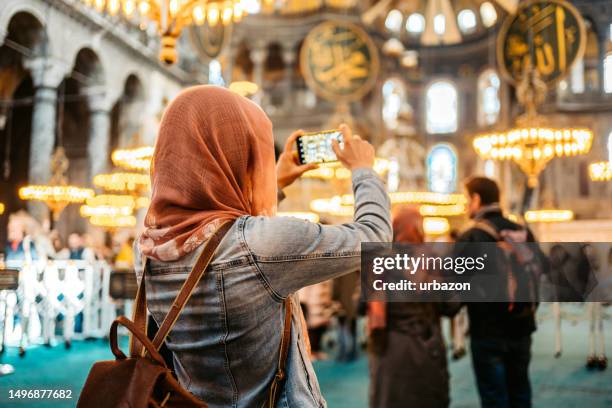 young woman taking pictures inside of hagia sofia in istanbul - islam temple stock pictures, royalty-free photos & images