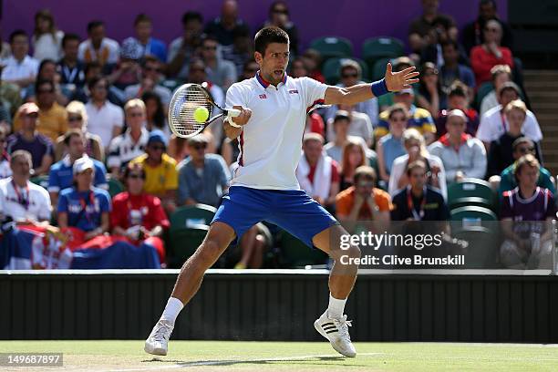 Novak Djokovic of Serbia returns a shot to Jo-Wilfried Tsonga of France during the Quarterfinal of Men's Singles Tennis on Day 6 of the London 2012...