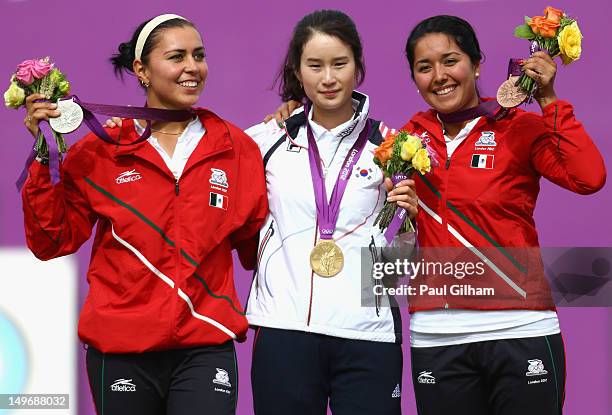 Bobae Ki of Korea celebrates with her Gold Medal on the podium, Aida Roman Arroyo of Mexico the Silver and Mariana Avitia Martinez the Bronze...