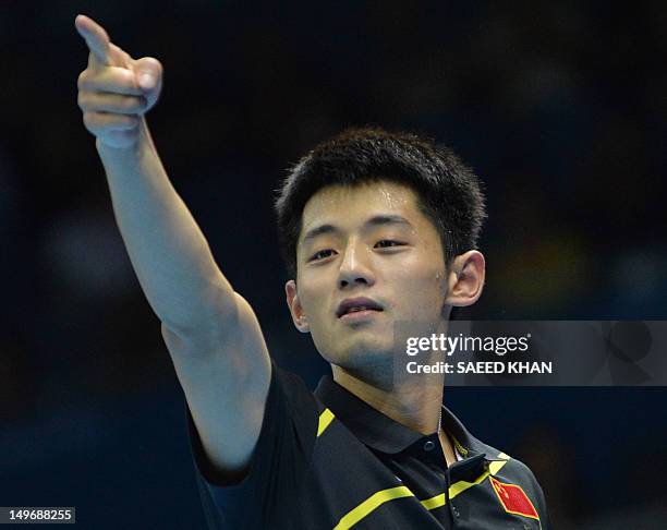 Zhang Jike of China celebrates after victory in his table tennis men's gold medal singles match against compatriot Wang Hao for the London 2012...