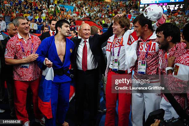 Russian President Vladimir Putin celebrates Tagir Khaibulaev of Russia's gold medal in the Men's -100 kg Judo on Day 6 of the London 2012 Olympic...