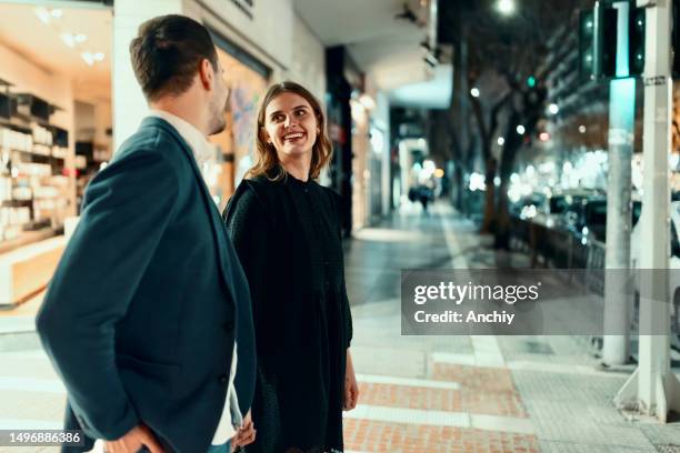 partners going out at night - couple crossing street stock pictures, royalty-free photos & images