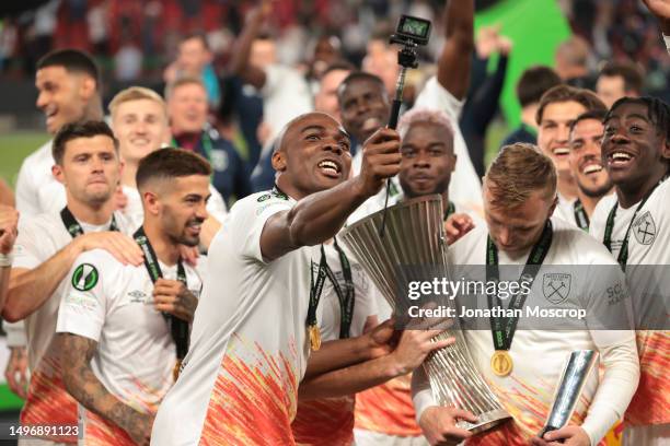 Angelo Ogbonna of West Ham United films the events as team mate Jarrod Bowen admires the trophy following the 2-1 victory in the UEFA Europa...