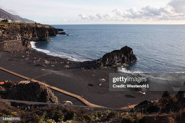 spain, la palma, people at charco verde beach - puerto naos stock pictures, royalty-free photos & images