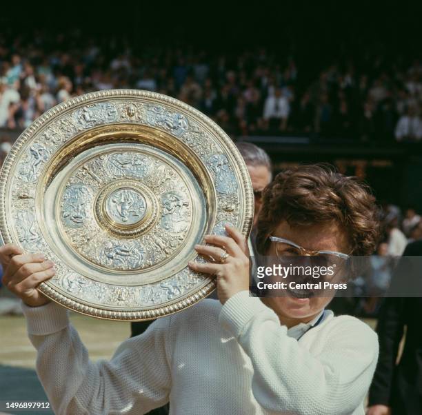 American tennis player Billie Jean King holds the winner's trophy after the Final of the Women's Singles tournament at Wimbledon, All England Lawn...