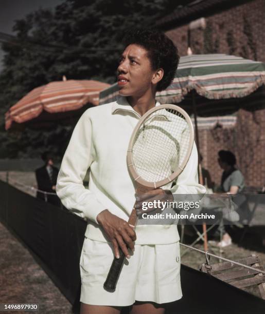 American tennis player Althea Gibson poses with her racket, 1957.