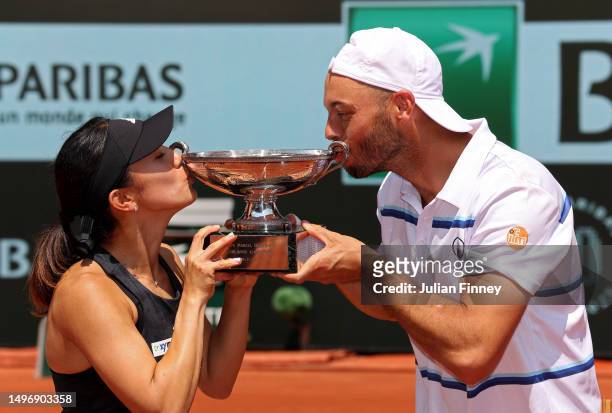 Miyu Kato of Japan and partner Tim Puetz of Germany kiss the trophy after winning match point against Bianca Andreescu of Canada and Michael Venus of...