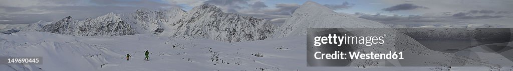 Norway, Lyngen, Skiers walking on snow